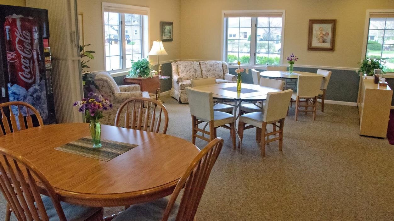 People can socialize and enjoy meals in this spacious dining area with natural light.
