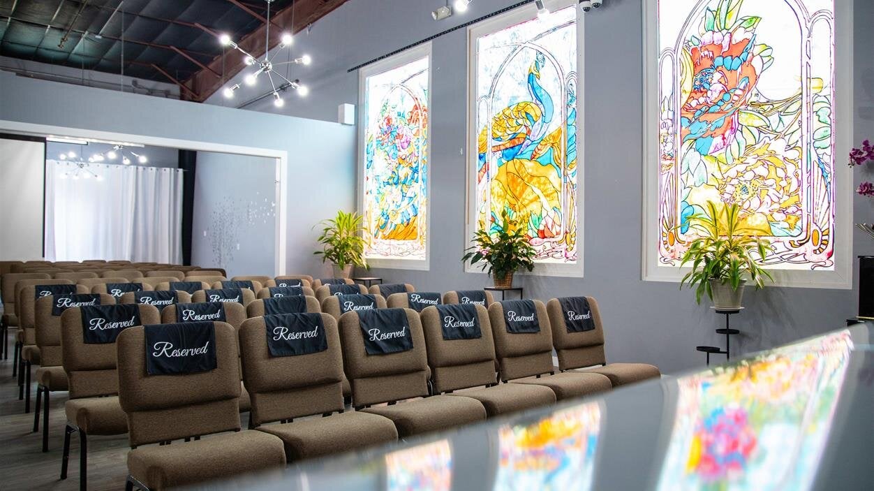 A room with chairs and stained glass windows