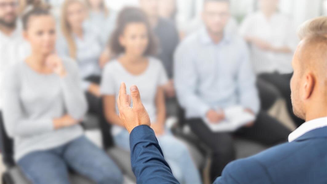 Attendees participate in a workshop led by a speaker discussing career growth strategies.