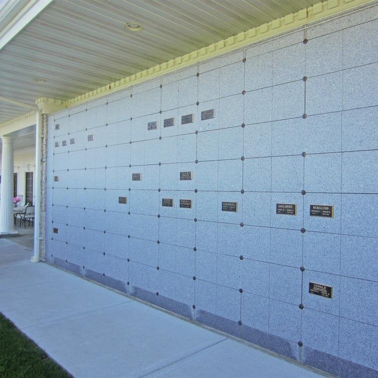 A wall of stone tiles with names on it