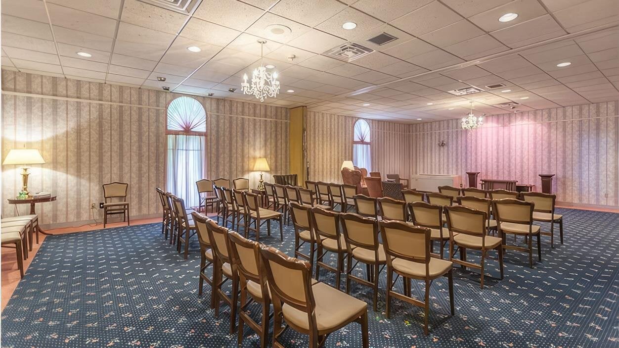 A room with chairs and a chandelier