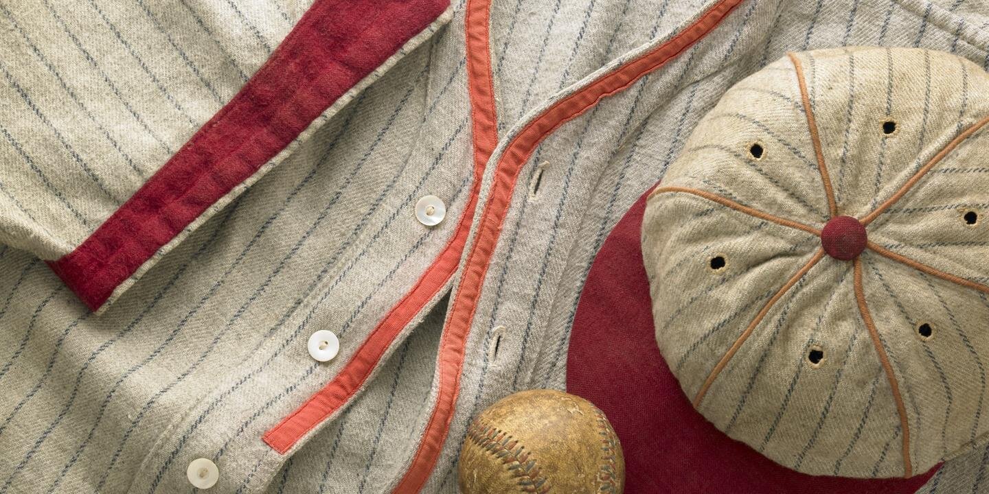 A baseball uniform and a baseball ball