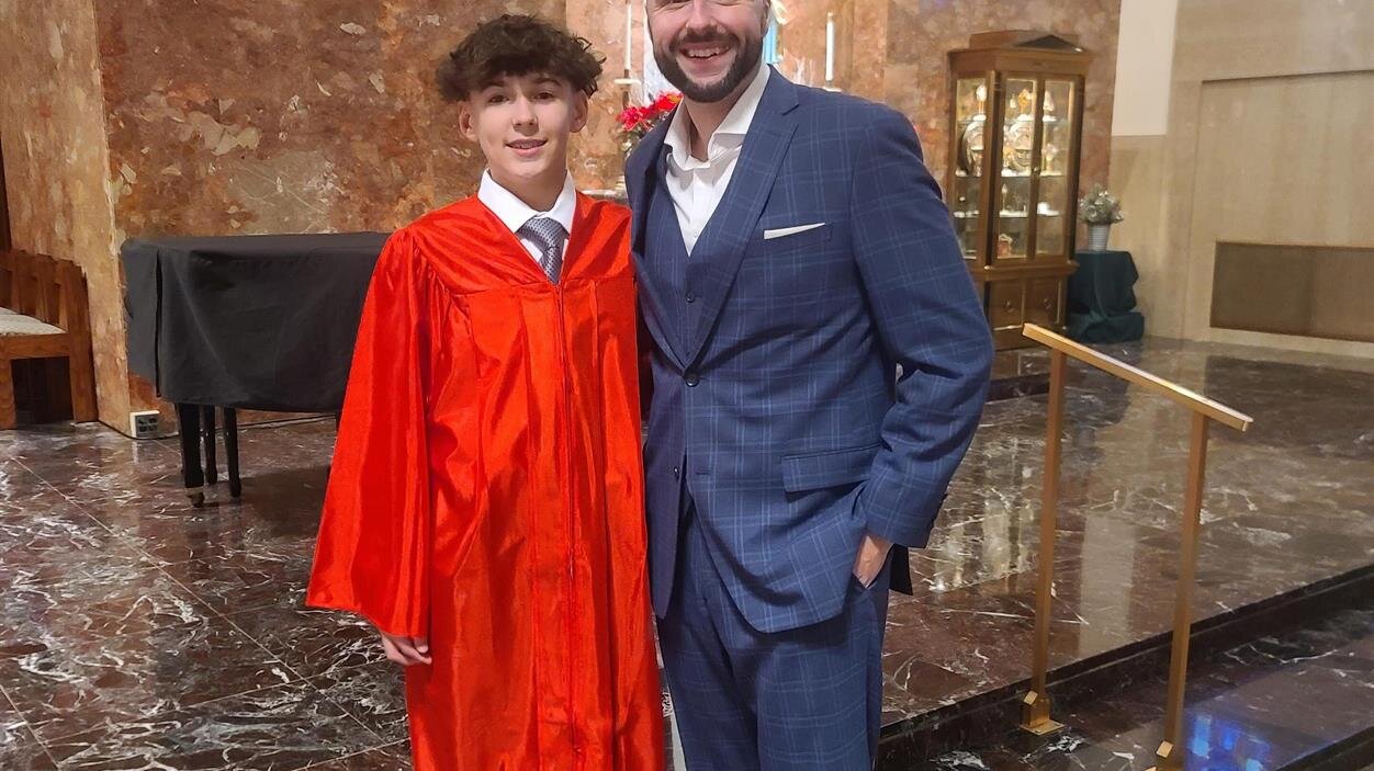 A man and boy posing for a picture