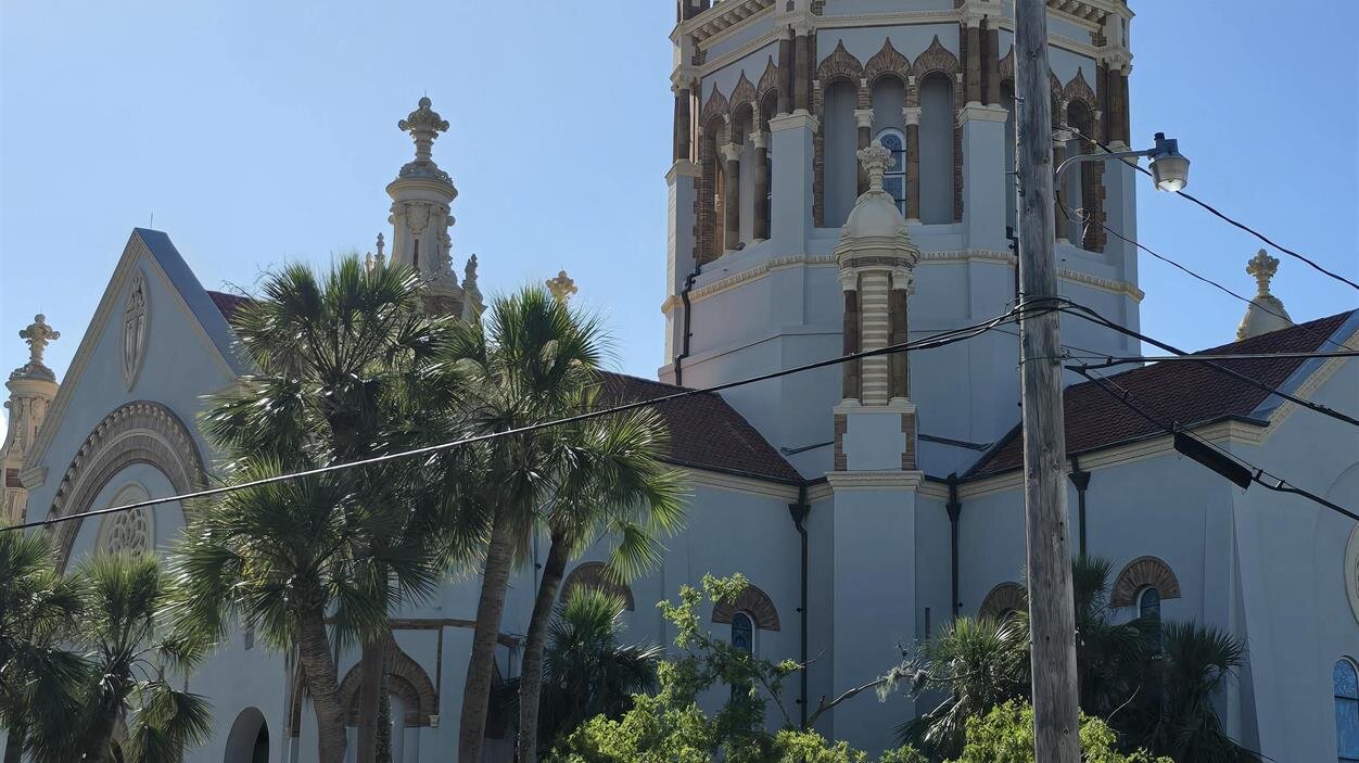 A white building with a dome on top