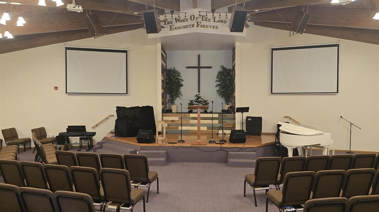 A room with a stage and chairs