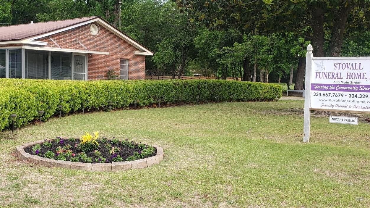 A house with a lawn and bushes