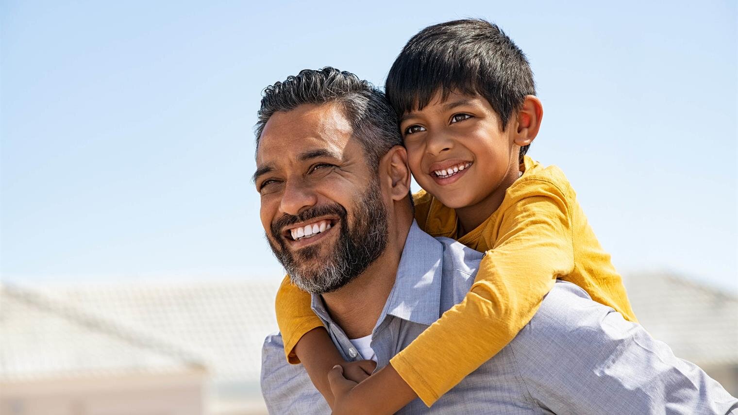 A man carrying a child on his back