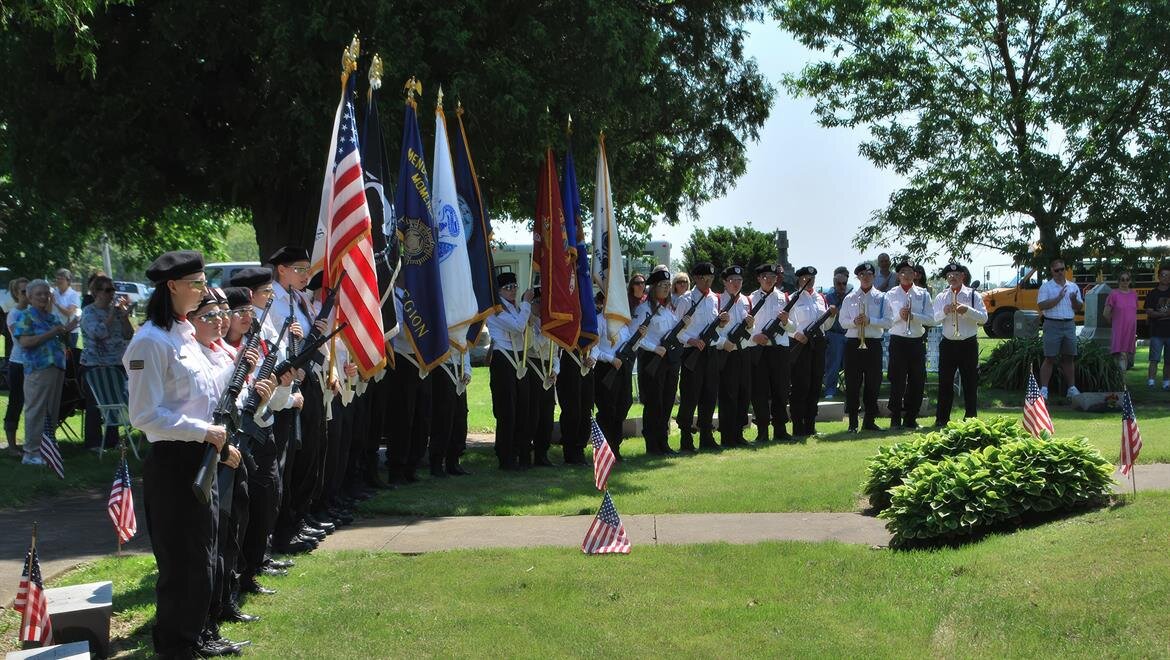 A group of people in uniform holding flags