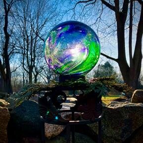 A glass ball with a colorful design on top of it