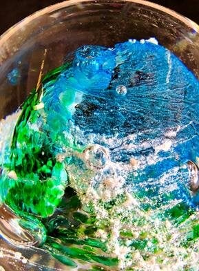 A glass ball with a blue and green object