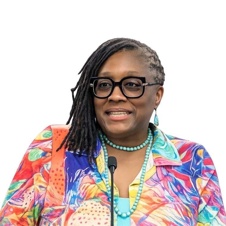 A woman wearing glasses and a colorful shirt