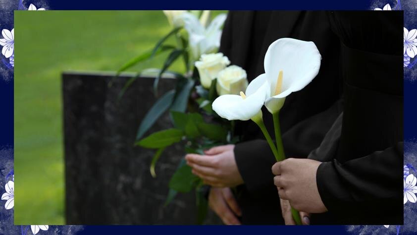 A person holding a white flower