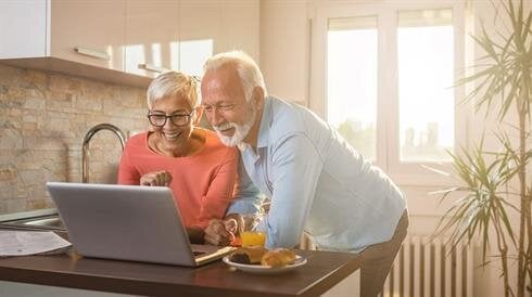 A man and woman looking at a laptop