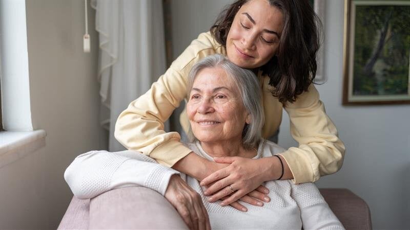 A woman hugging an older woman