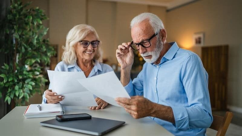 A man and woman looking at papers