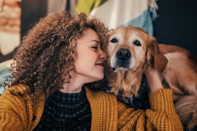 A woman holding a dog