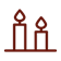 Decorative candles stand on a holder, casting a warm glow in a tranquil indoor space.