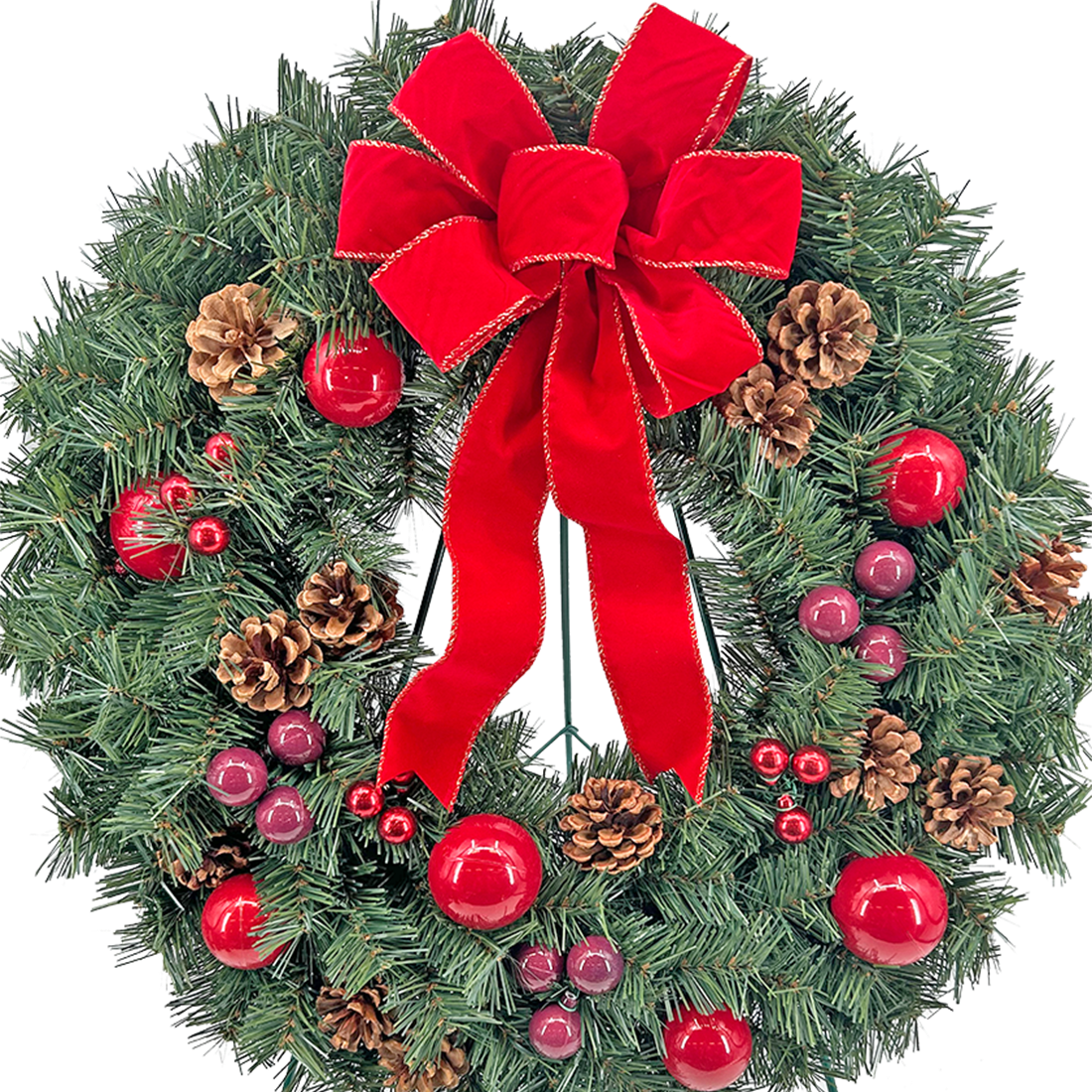 A wreath with red ribbon and pine cones