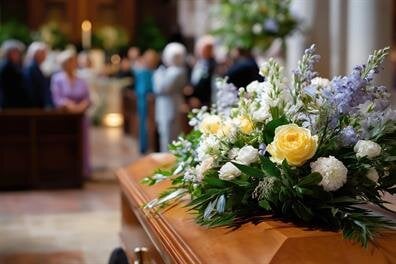 Family and friends stand together in a church during a memorial service for a loved one.