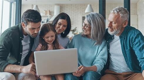 A group of people looking at a laptop
