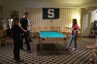 A group of people playing pool