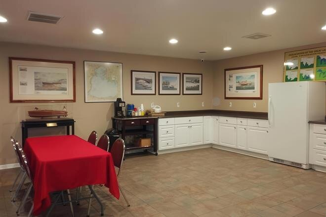 A room with a red table and chairs