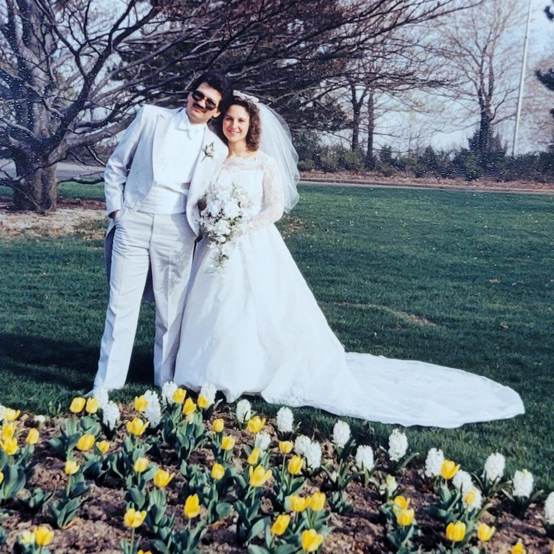 A man and woman in white wedding attire