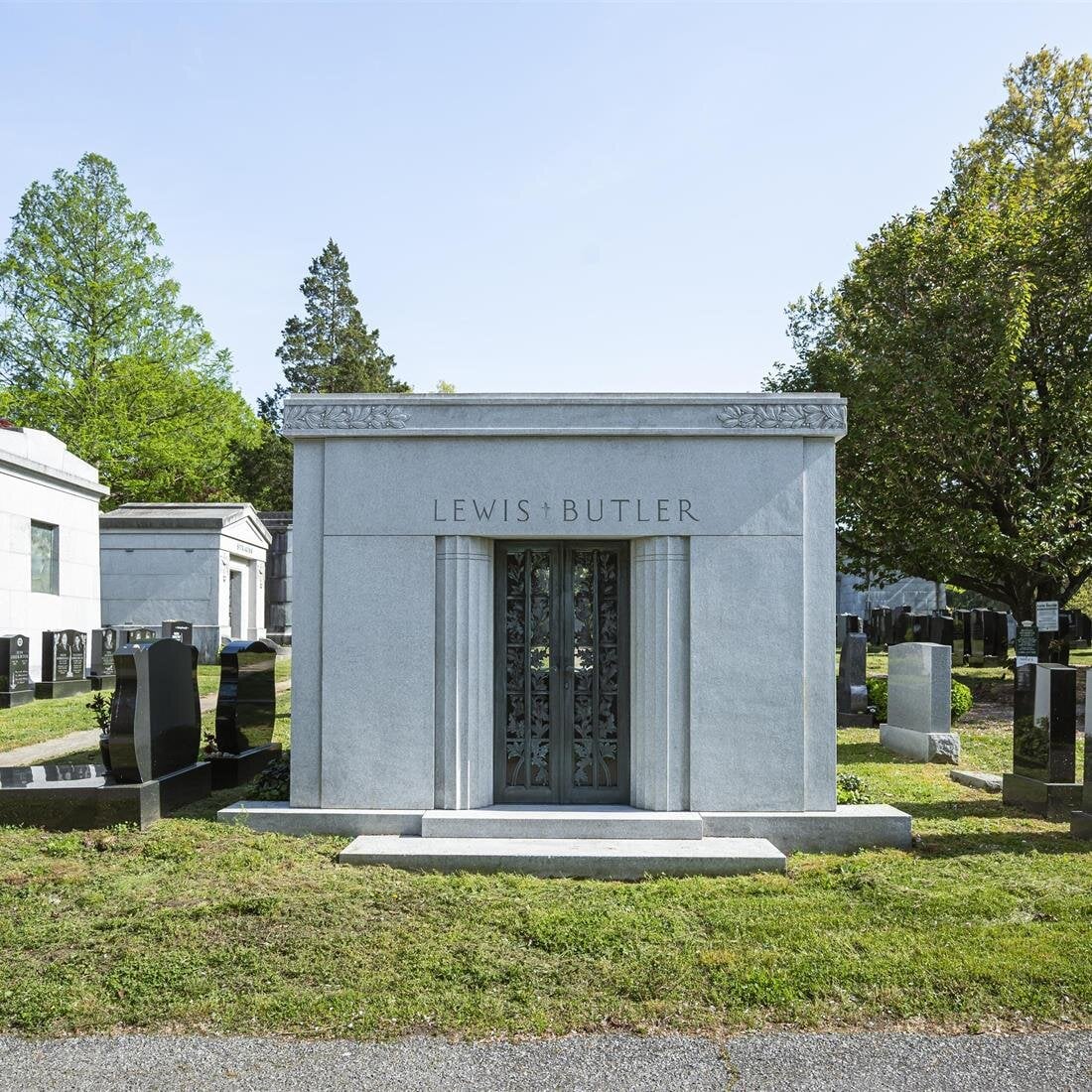 A grave stone with a door and a door