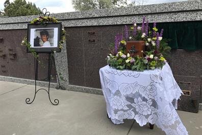 A funeral casket with a picture of a woman
