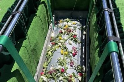 A coffin filled with flowers
