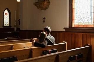 two people inside a chapel thinking about a funeral