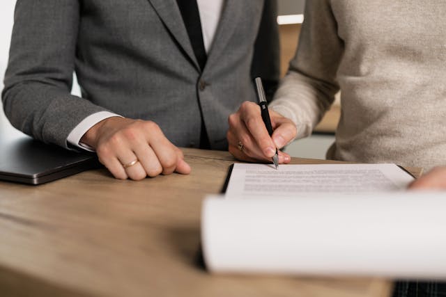 Individual signing advance funeral planning paperwork with a professional advisor in Albany, NY