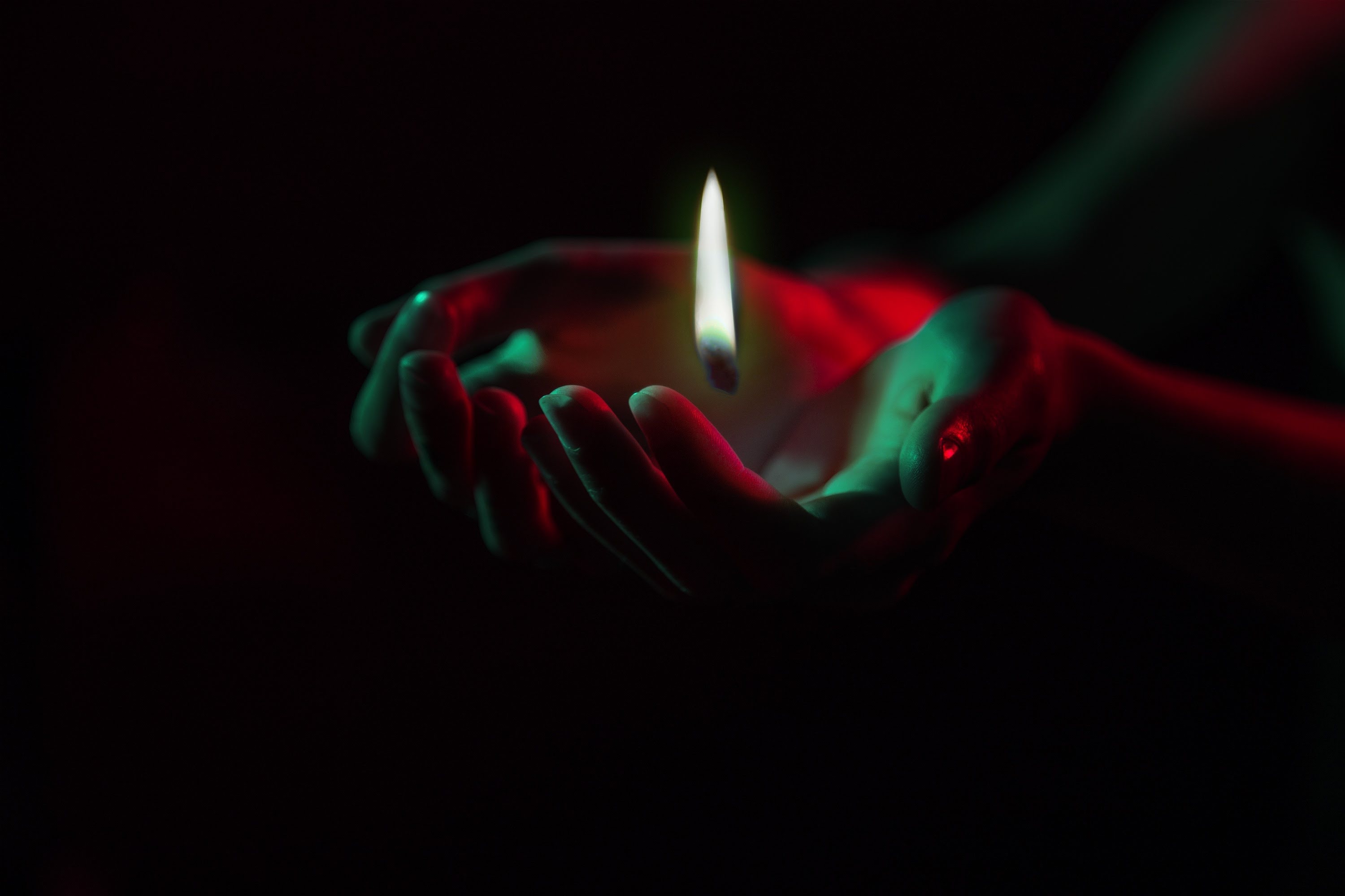 Gentle candlelight held in caring hands symbolizing remembrance and compassion at a Bellbrook, OH funeral home and cremations service