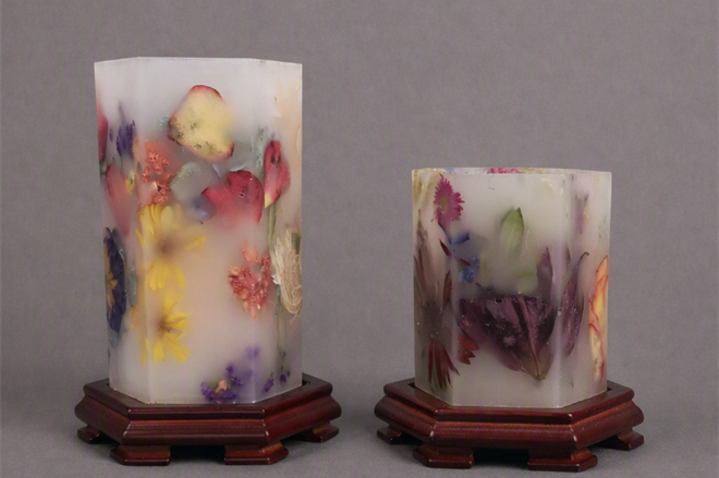 A pair of candles with flowers on them