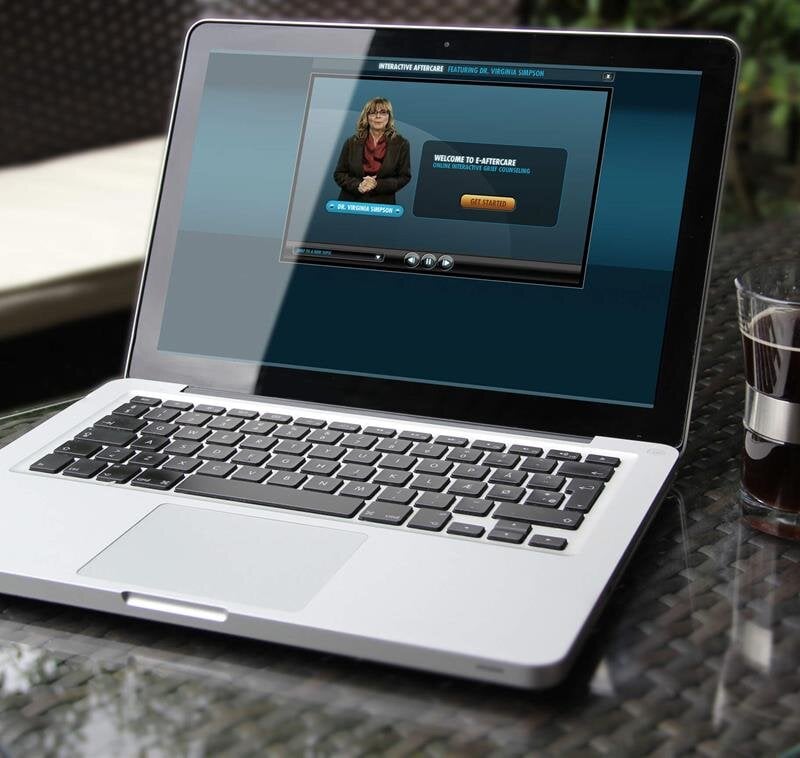 A laptop displays a presentation with a speaker, while coffee sits on a chic table.