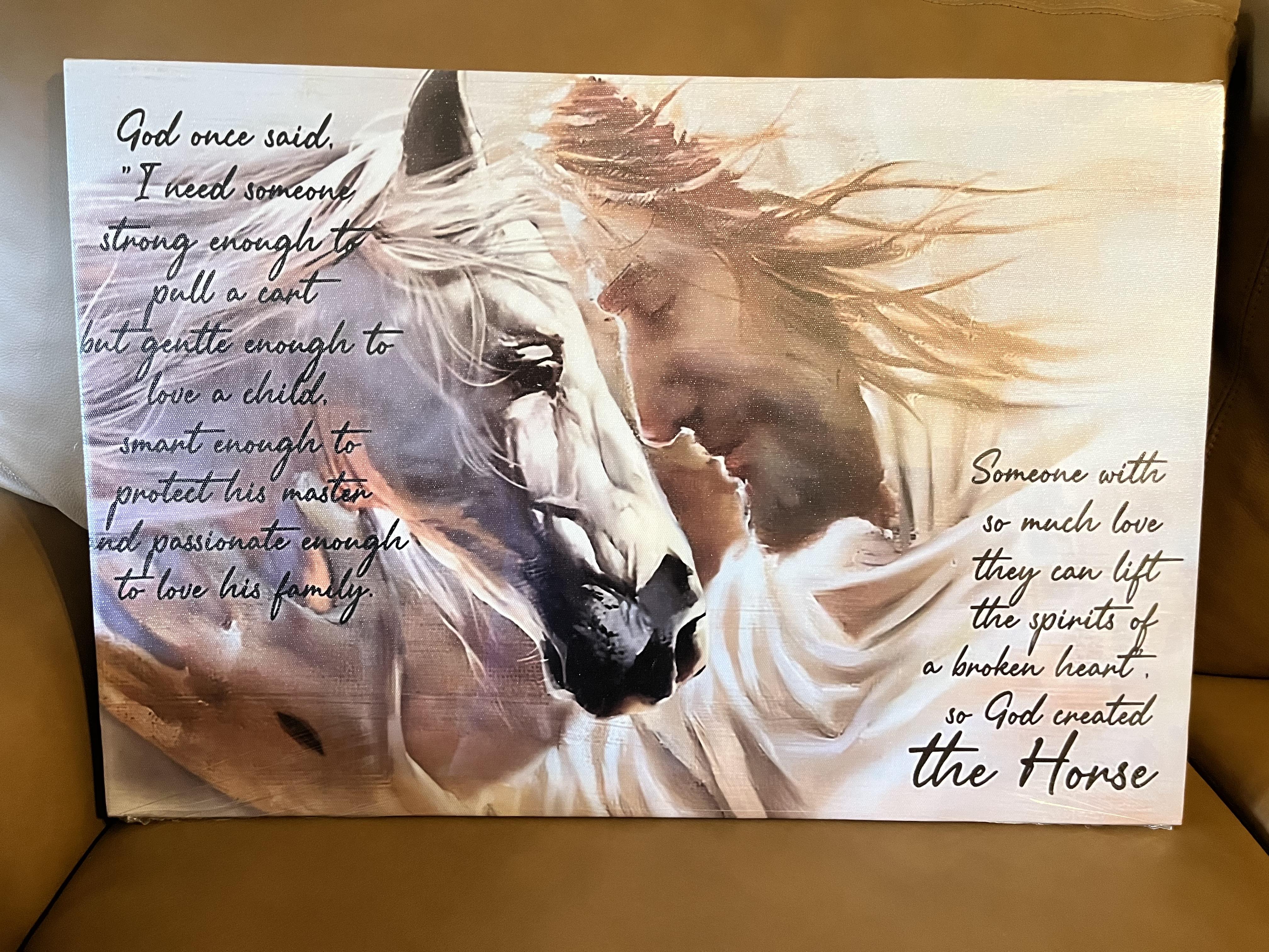 A striking canvas artwork shows a man and a horse sharing a peaceful moment in nature.