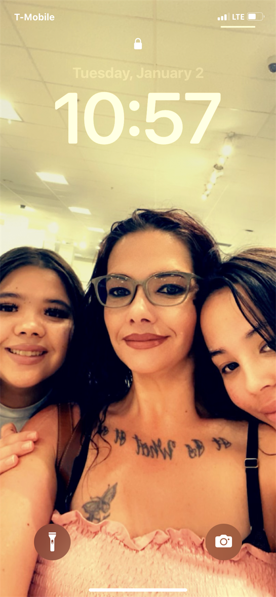 Three friends gather together, posing and smiling while taking a selfie in a store.