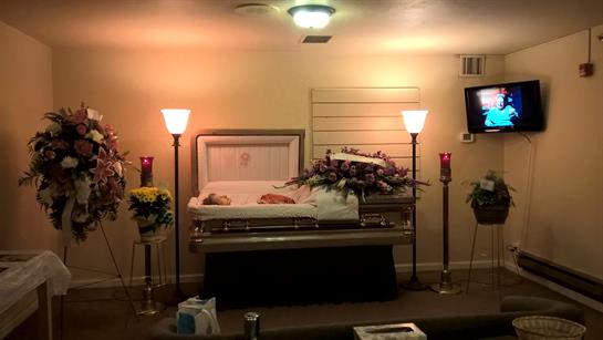 A coffin with flowers and candles