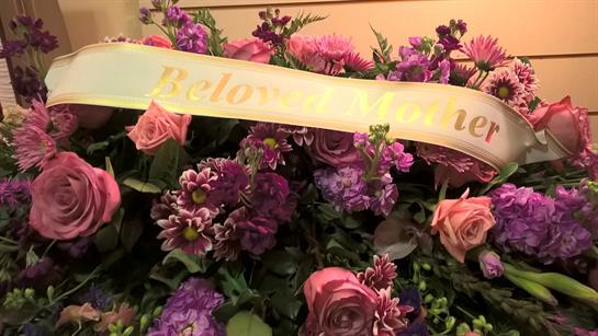 A bouquet of flowers with a sign