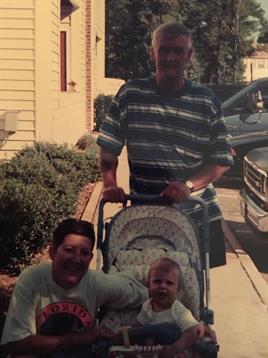 A man pushing a baby in a stroller