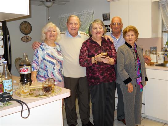 A group of people standing in a kitchen