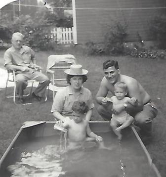 A family sitting in a pool