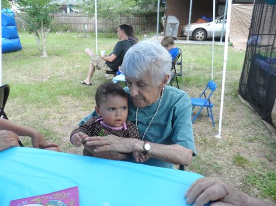 An old woman holding a baby