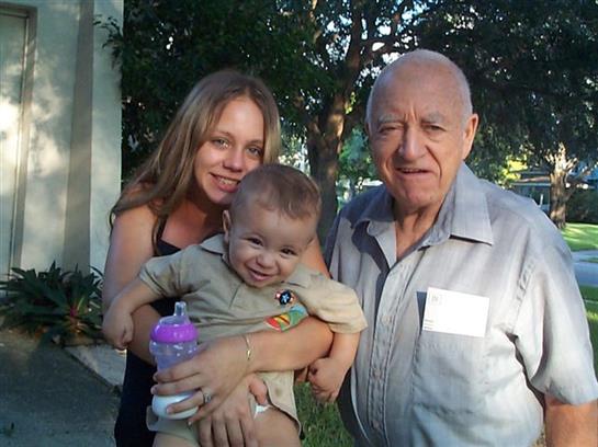 A man and woman holding a baby