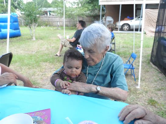 An old woman holding a baby