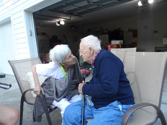 A man and woman sitting in a chair