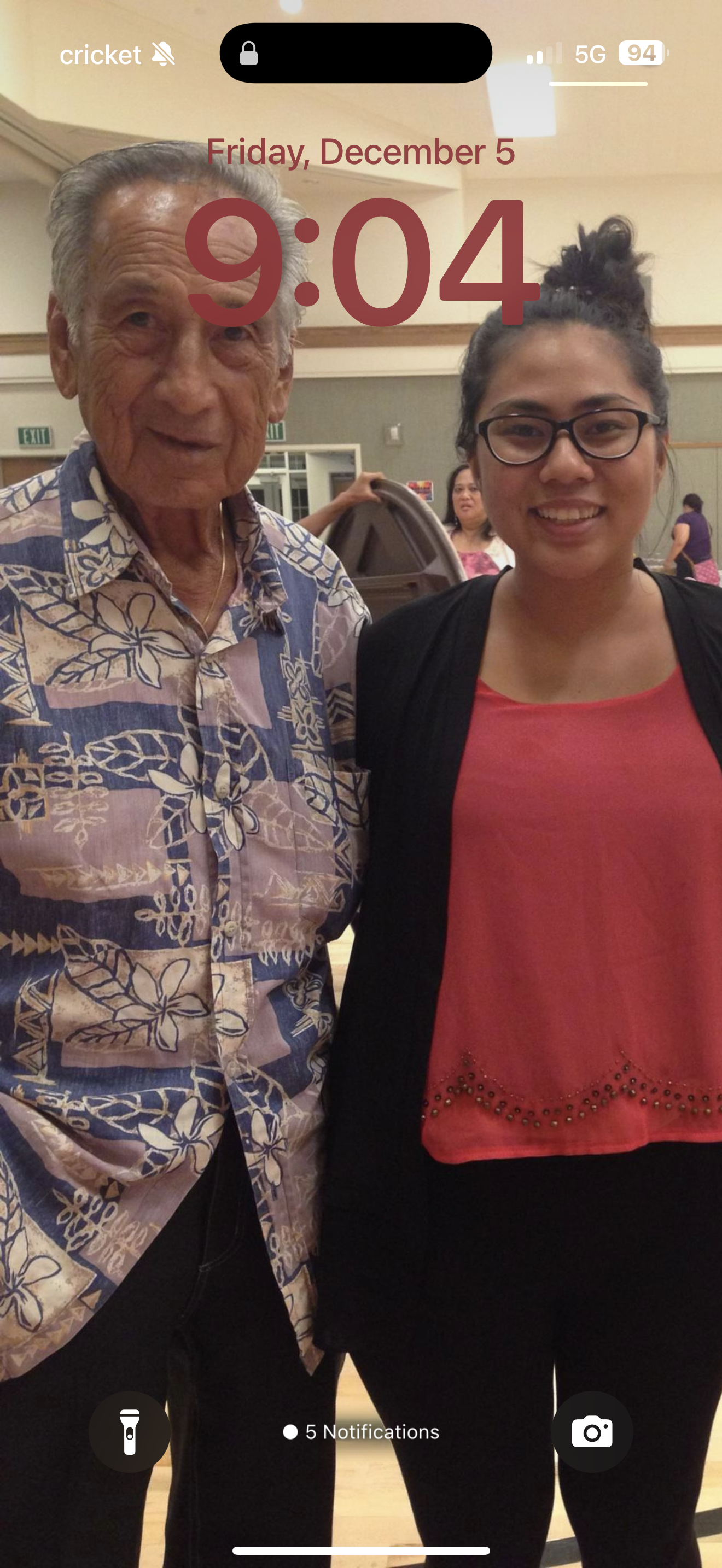 A woman standing next to an old man