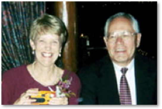 A man and woman smiling