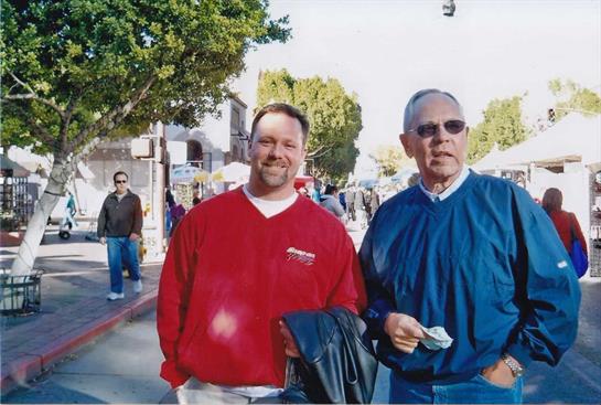 A man standing next to another man