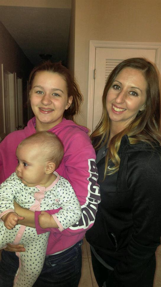 A group of women holding a baby